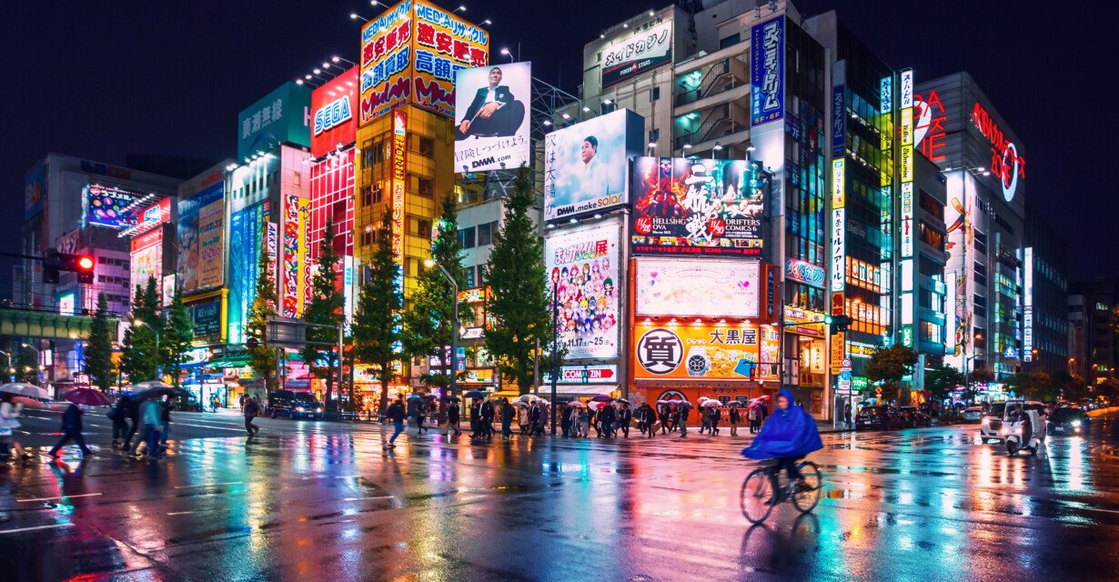 Neon lights and billboard advertisements on buildings at Akihabara at rainy night, Tokyo, Japan