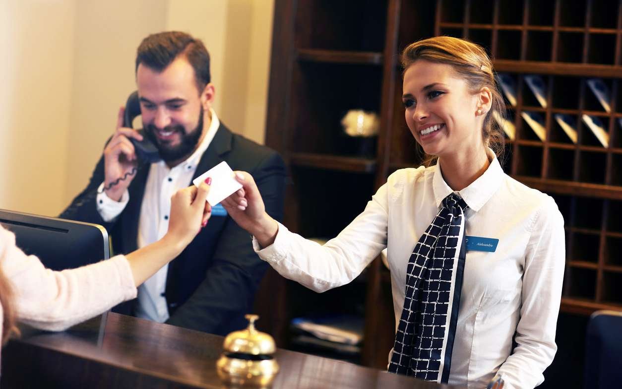 Guests getting key card in hotel
