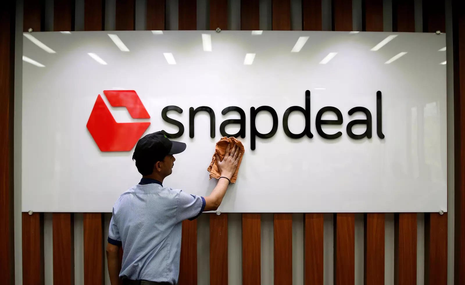 file-photo-an-employee-cleans-a-snapdeal-logo-at-its-headquarters-in-gurugram